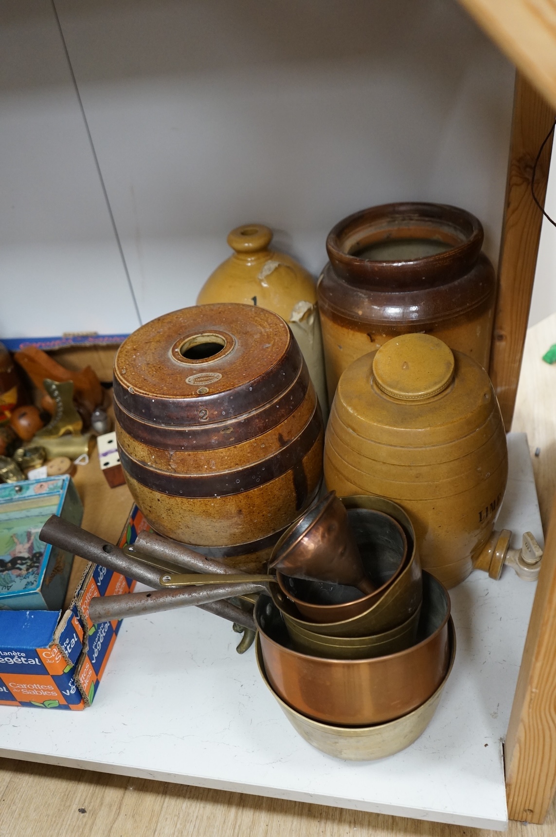 Four Victorian stoneware flagons / jars, five copper/brass saucepans and a funnel, largest 33cm high